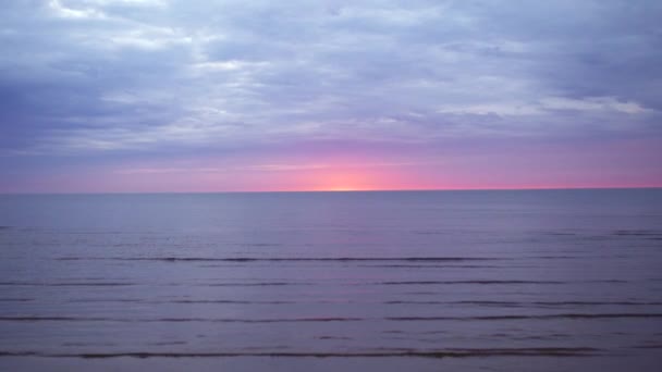 Amazing dark scenic vivid crimson rare red sunset with violet and magenta colors at the Baltic Sea with small sun at the horizon — Stock Video