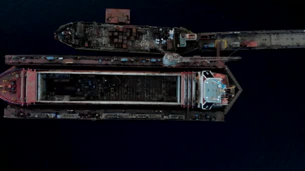 空中:メインテナンブの下のポートドックで美しい4k巨大な船 - 上からダウガバ川風の風の強い天候の鳥の目のビュー - サンセットでドローントップビュー — ストック動画