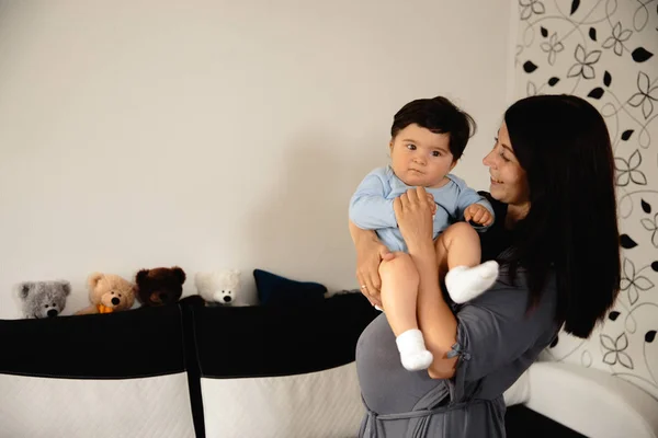 Madre jugando con el oso de peluche y su hijo bebé piso interior - Niño asiático de etnia mixta con camisa de cuerpo azul con dibujos animados oso sonriente Embarazada — Foto de Stock