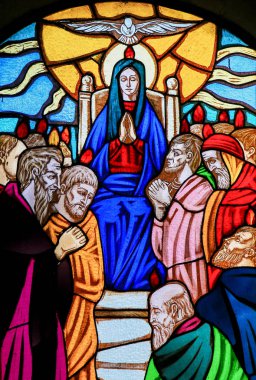 Ostuni, Italy - March 14, 2015: Stained glass window depicting Mother Mary and the Disciples of Christ at Pentecost in the Church of Ostuni, Apulia, Italy. clipart