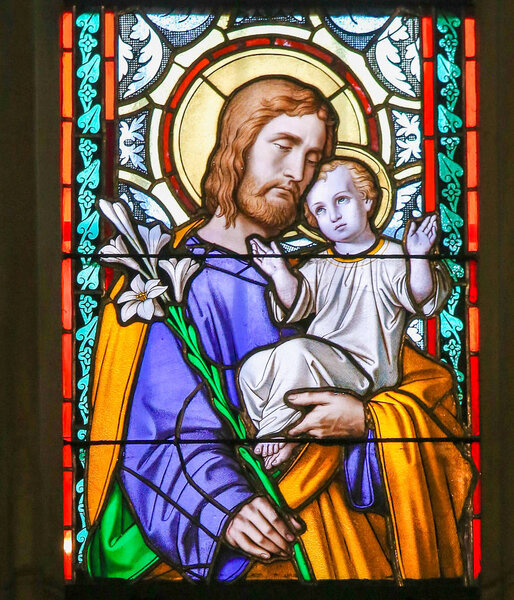 Prague, Czech Republic - April 2, 2016: Stained Glass window in St. Vitus Cathedral, Prague, depicting Saint Joseph and the Child Jesus