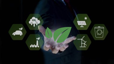 Sürdürülebilir Kalkınma Hedefleri için yeşil yaprağı tutan iş adamları. İklim tarafsız uzun vadeli stratejisi. Dekarbonizasyon, sera gazı emisyonu hedefi. Çevreye karşı sorumluluk. 