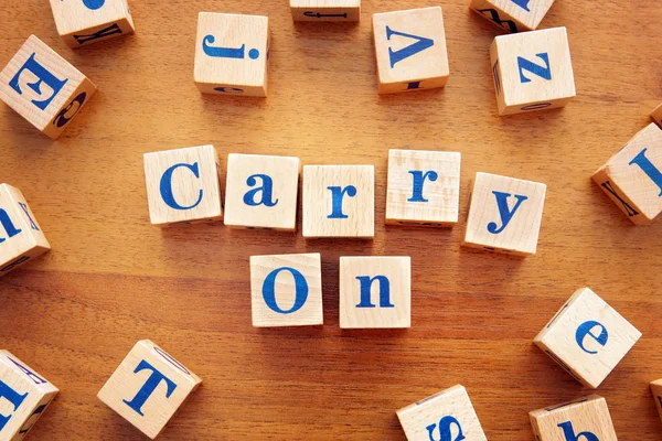 Carry on. Conceptual image with the text made from wooden cubes