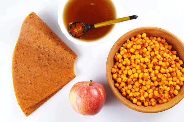 Ingredients for fruit pastille made of sea buckthorn and apples with honey on white background