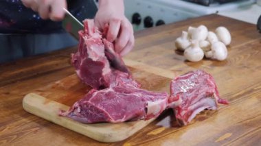 The chef cuts raw meat with the knife. Cooking. Preparing, Cut Raw meat. Barbecue party.