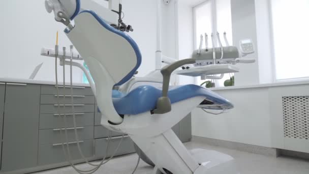 Escritório dentário vazio. Armário de dentista moderno. A baixar a cadeira dentária. Teethcare, saúde dentária . — Vídeo de Stock