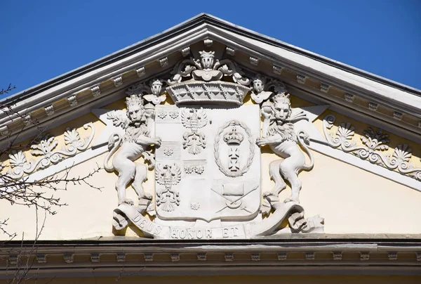 The coat of arms of Baron Bode-Kolychev is installed on the pediment of the main house of the estate in Moscow in 1876. Russia, Moscow, April 2019.