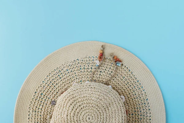 Summer hat top view on blue background