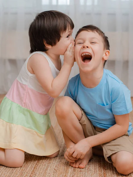 Funny children, brother and sister are friends whisper and laugh. — Stock Photo, Image