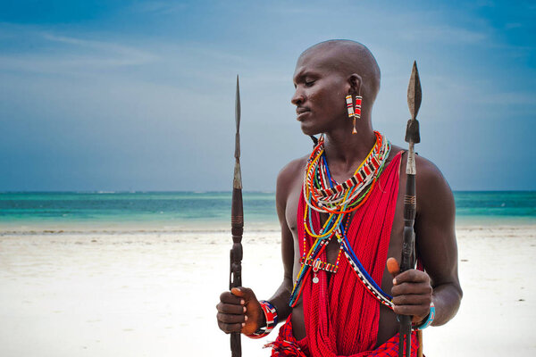 Maasai warrior on the beach Diani Beach, Kenya Mombasa January 26 2012