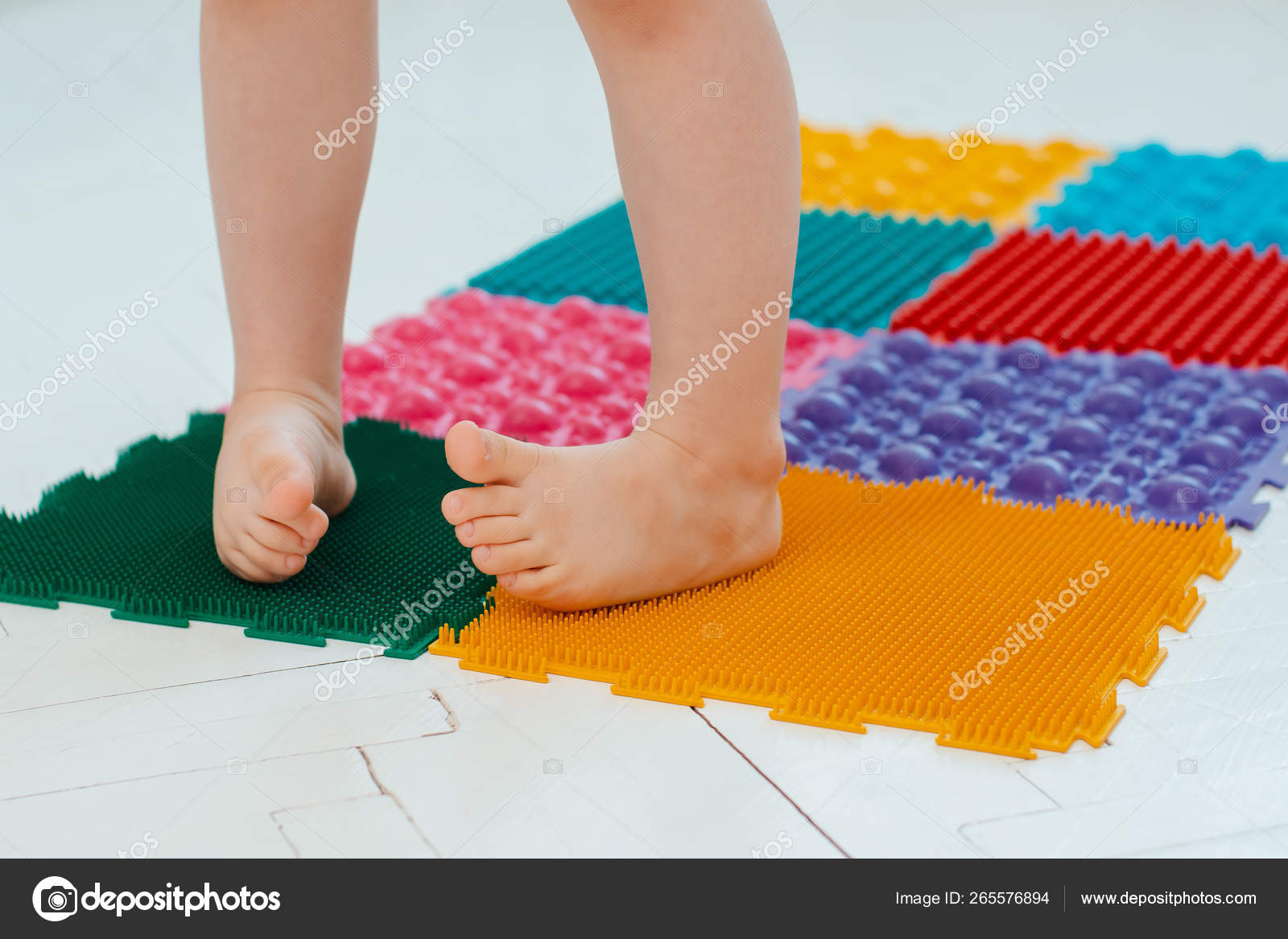 Toddler On Baby Foot Massage Mat Exercises For Legs On Orthopedic