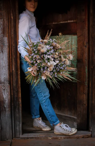 Autumn bouquet of wildflowers in the hands of a hipster florist girl — Stock Photo, Image