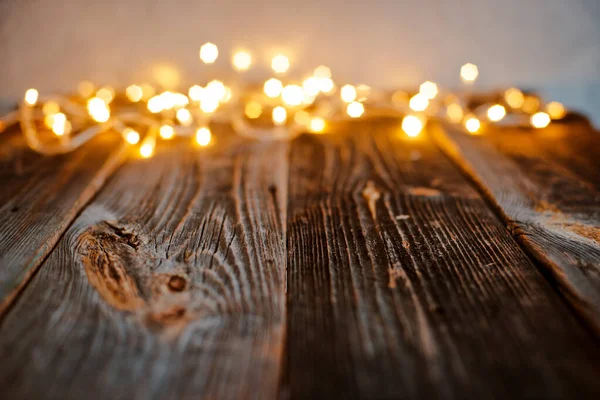 Pusty stary drewniany blat z zamazanym złotym bokeh Christmas lights abstrakcyjne tło. — Zdjęcie stockowe