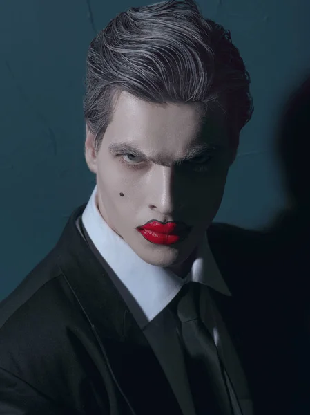 portrait of male model with white face and red lips