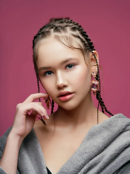 young model with braided hair posing at studio