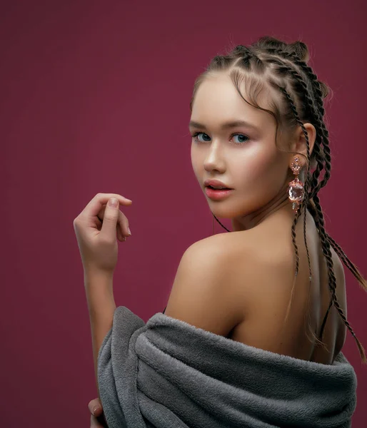 young model with braided hair posing at studio