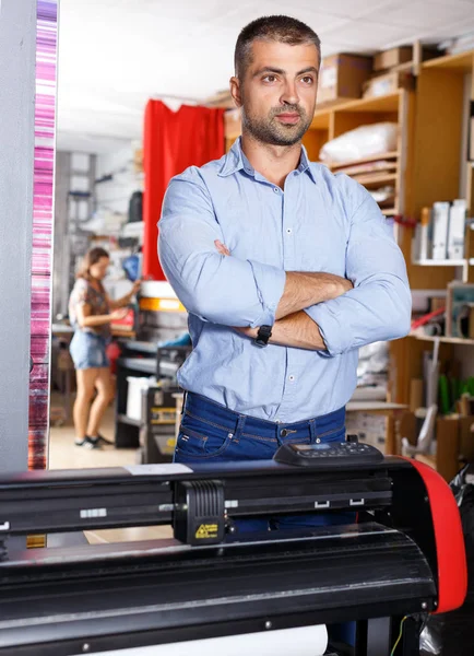 portrait of a working man at printer studio