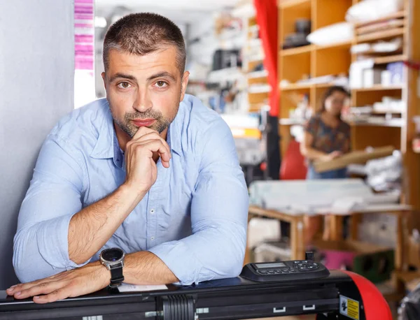 portrait of a working man at printer studio