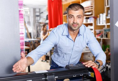 portrait of a working man at printer studio clipart