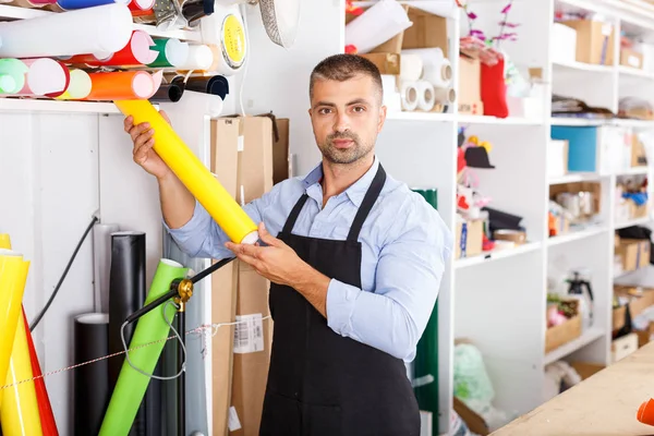 Man designer and print operator with vinyl paper at print manufacturing — Stock Photo, Image