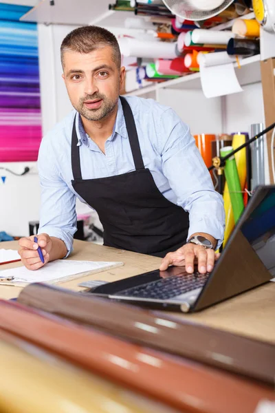 portrait of a working man at printer studio