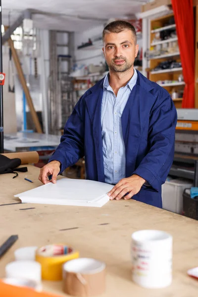 portrait of worker at printer studio