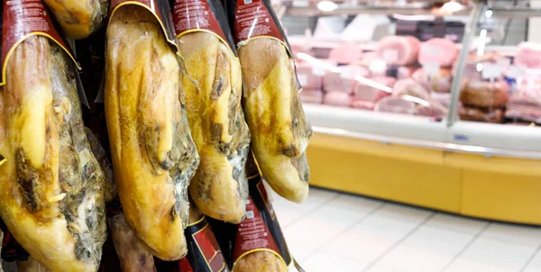 pork ham, jamon on the shop window of a supermarket