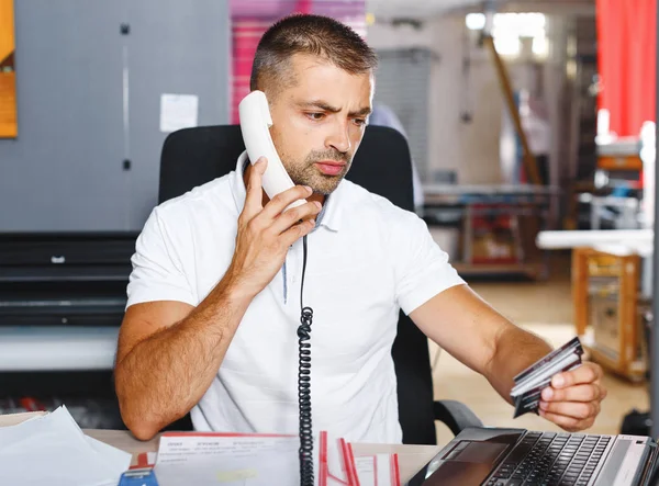 portrait of a working man at printer studio