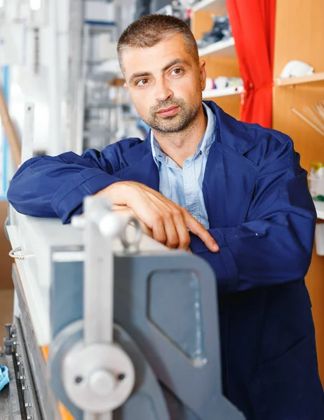 portrait of a working man at printer studio