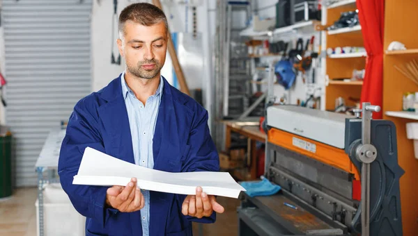 portrait of a working man at printer studio