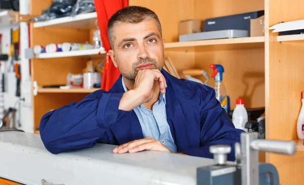 portrait of a working man at printer studio