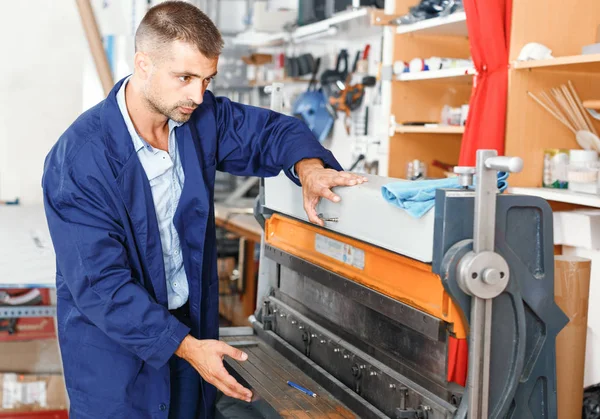 portrait of a working man at printer studio