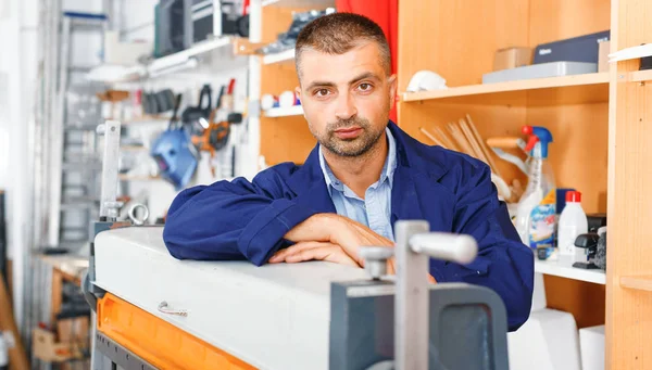 portrait of a working man at printer studio