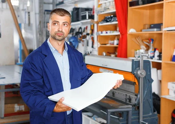 portrait of a working man at printer studio