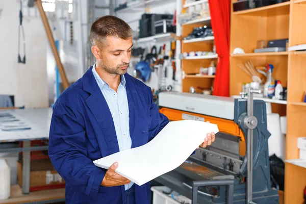 portrait of a working man at printer studio