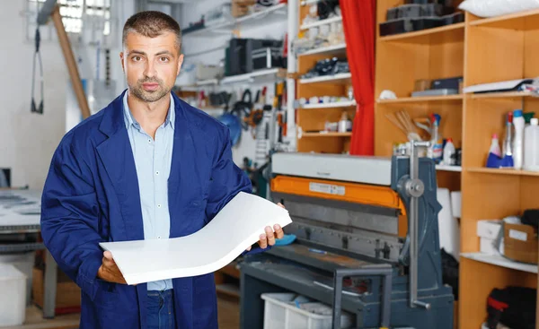 portrait of a working man at printer studio