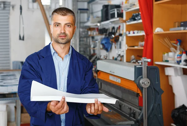 Profession,job,people,workman in special clothes with paper — Stock Photo, Image