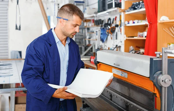 Profession,job,people,workman in special clothes with paper — Stock Photo, Image