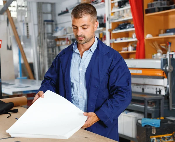 Profession,job,people,workman in special clothes with paper — Stock Photo, Image