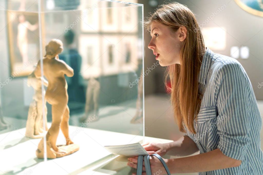 visitor looking art object in art gallery