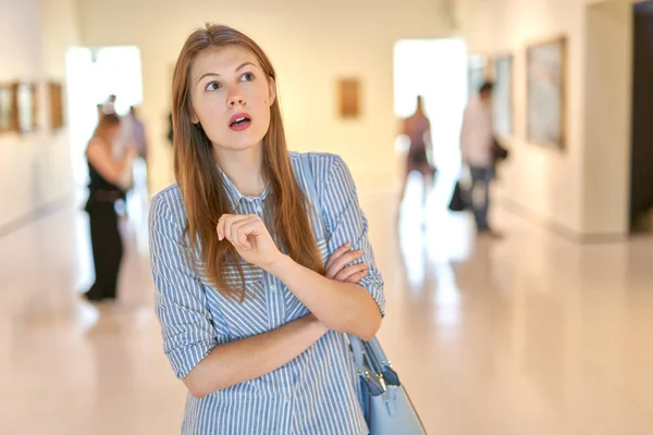 Kvinna besökare i historiskt museum tittar på konstföremål — Stockfoto