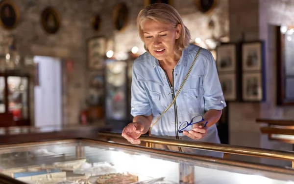 Femme visiteuse dans le musée historique regardant un objet d'art. — Photo