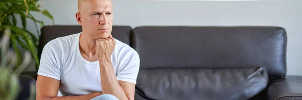 Feeling depressed. Desperate man sitting on the couch at home — Stock Photo, Image