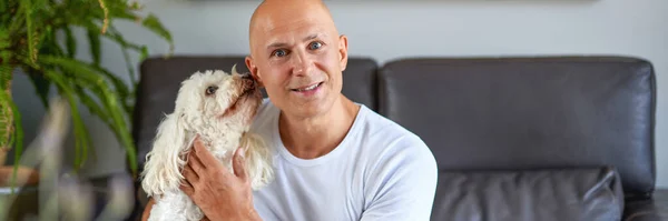 Hombre guapo con lindo perro en casa —  Fotos de Stock