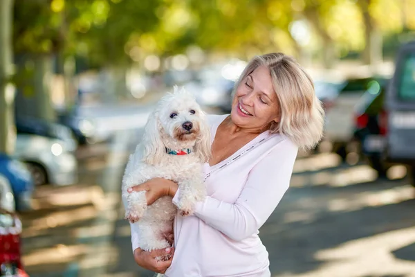 Äldre kvinna som går med hund utomhus — Stockfoto