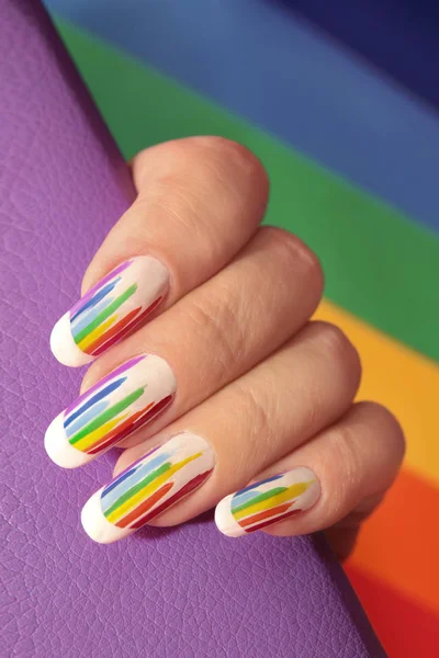 Rainbow design on long oval nails. Nail art. Multicolored French manicure.