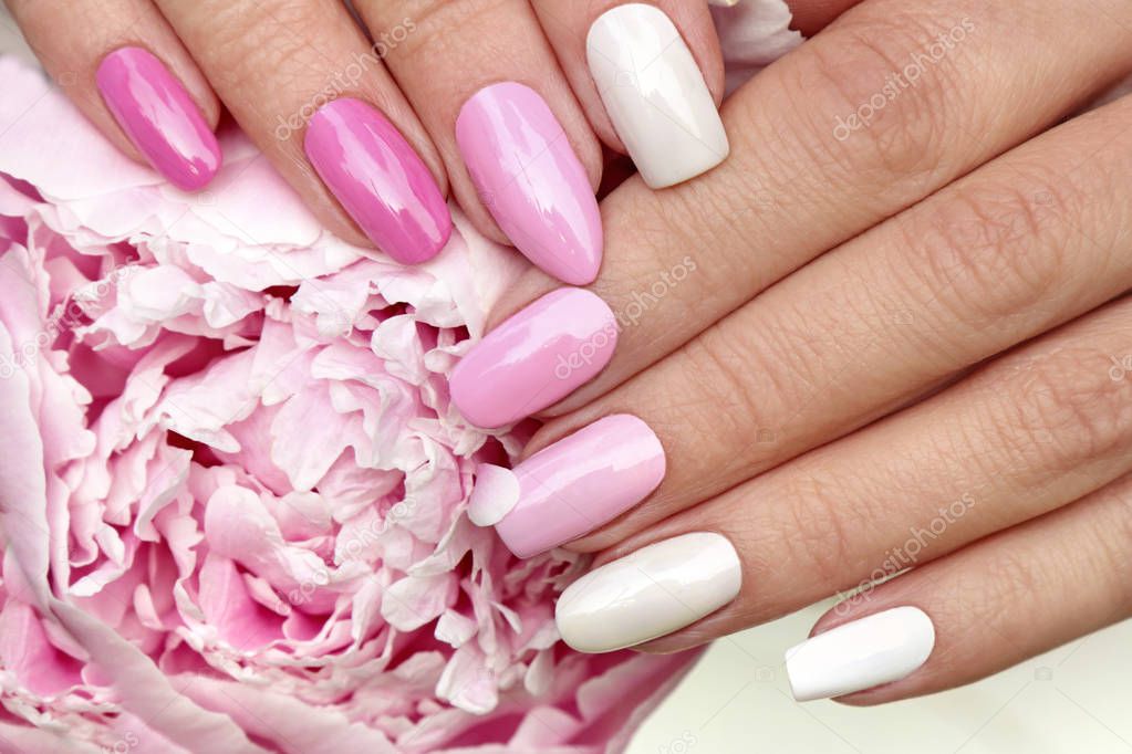 Light pink, pastel manicure on various shapes of nails with peony closeup.