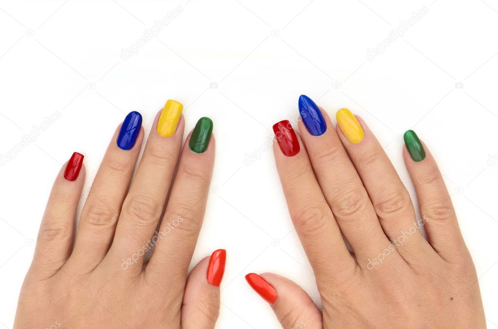 Multicolored bright manicure with different shapes of square, oval, sharp nails on a white background.