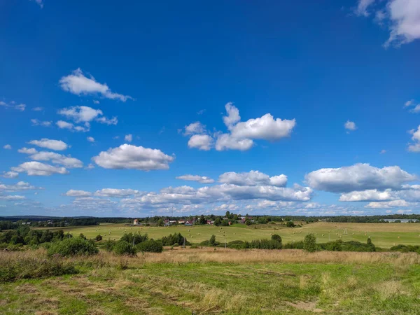 The village way of life. Summer landscape in Sunny weather with clouds. Agricultural fields.