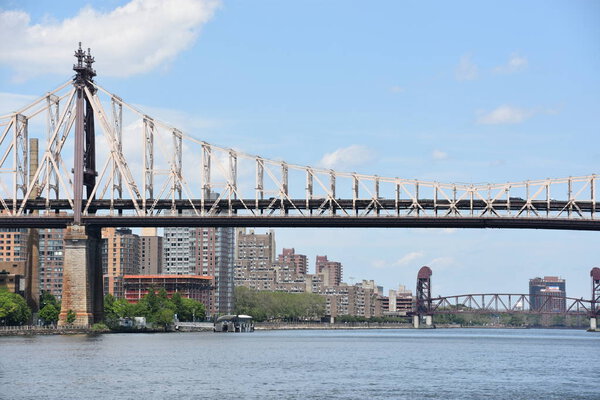 NEW YORK, NY - MAY 26: View of Queensboro Bridge in New York City, from Gantry Plaza State Park in Queens, New York, as seen on May 26, 2019. It is a cantilever bridge over the East River in New York City that was completed in 1909.